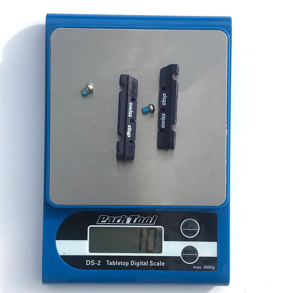 SwissStop BXP brake pads being weighed on scale.webp