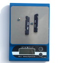SwissStop BXP brake pads being weighed on scale.webp