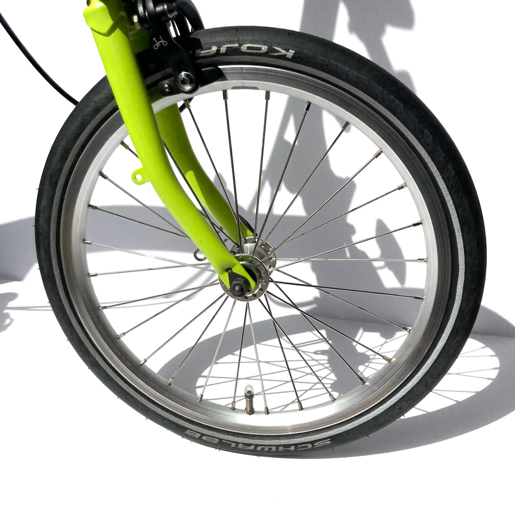 Brompton standard 16 inch front bicycle wheel - on a Brompton folding bike.webp