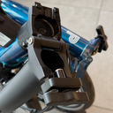 Brompton Anti Rotation Hinge Clamp | Wide | Composite | fitted to blue P Line MK2 alloy stem - open.webp